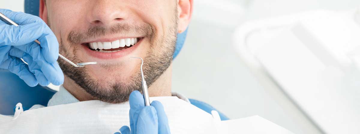 The doctor is providing a teeth whitening service in Fatemeh Hadjian DDS in Palm Desert, CA.